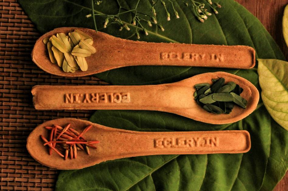 Close-up of hands holding herbal powder in a traditional Indian brass bowl, representing authentic Ayurvedic practices